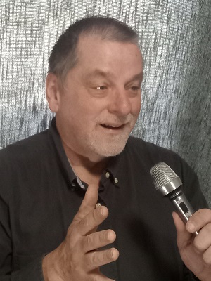 Jerry Penner, Speaker and Financial Coach, hand out and smiling